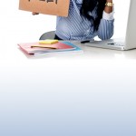 woman covering face in front of computer at work and holding a sign that says: help