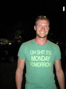 Steve Zwerink wearing a green t-shirt that says: Oh Shit It's Monday Tomorrow