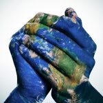 hands painted as the earth clasped together